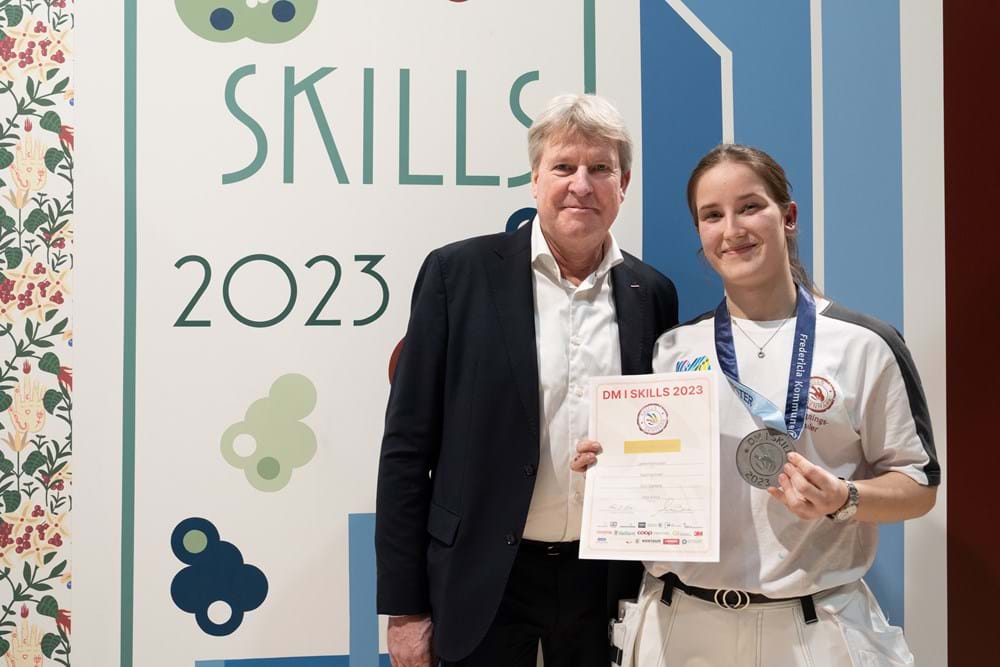 Her overrækker Danske Malermestres formand Per Vangekjær beviset for, at Lærke Rasmussen er Danmarks bedste bygningsmalerlærling. Foto Alex Tran.